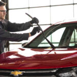 Chevrolet service technician installing new windshield wipers